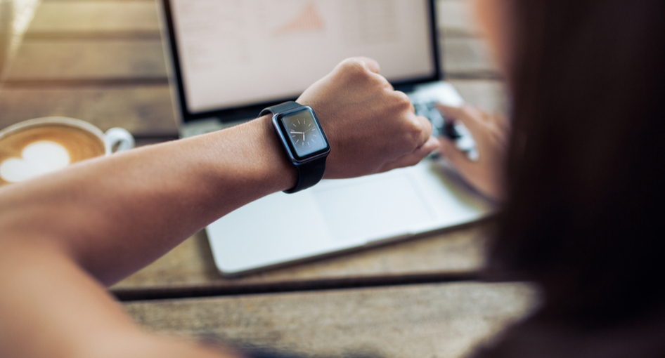 A woman checking the time on a watch.