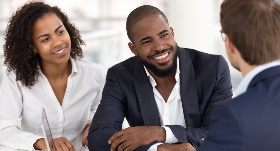 A couple taking to a financial planner.