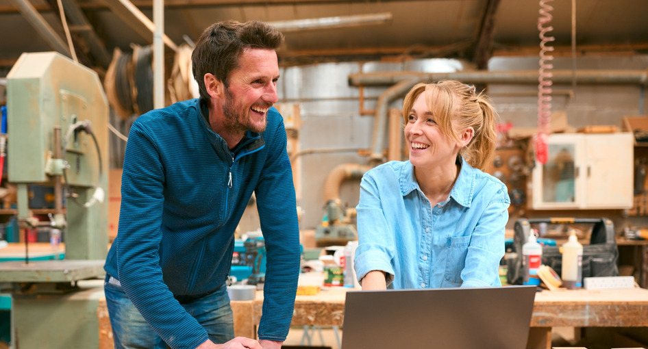 Two people in a woodwork workshop.